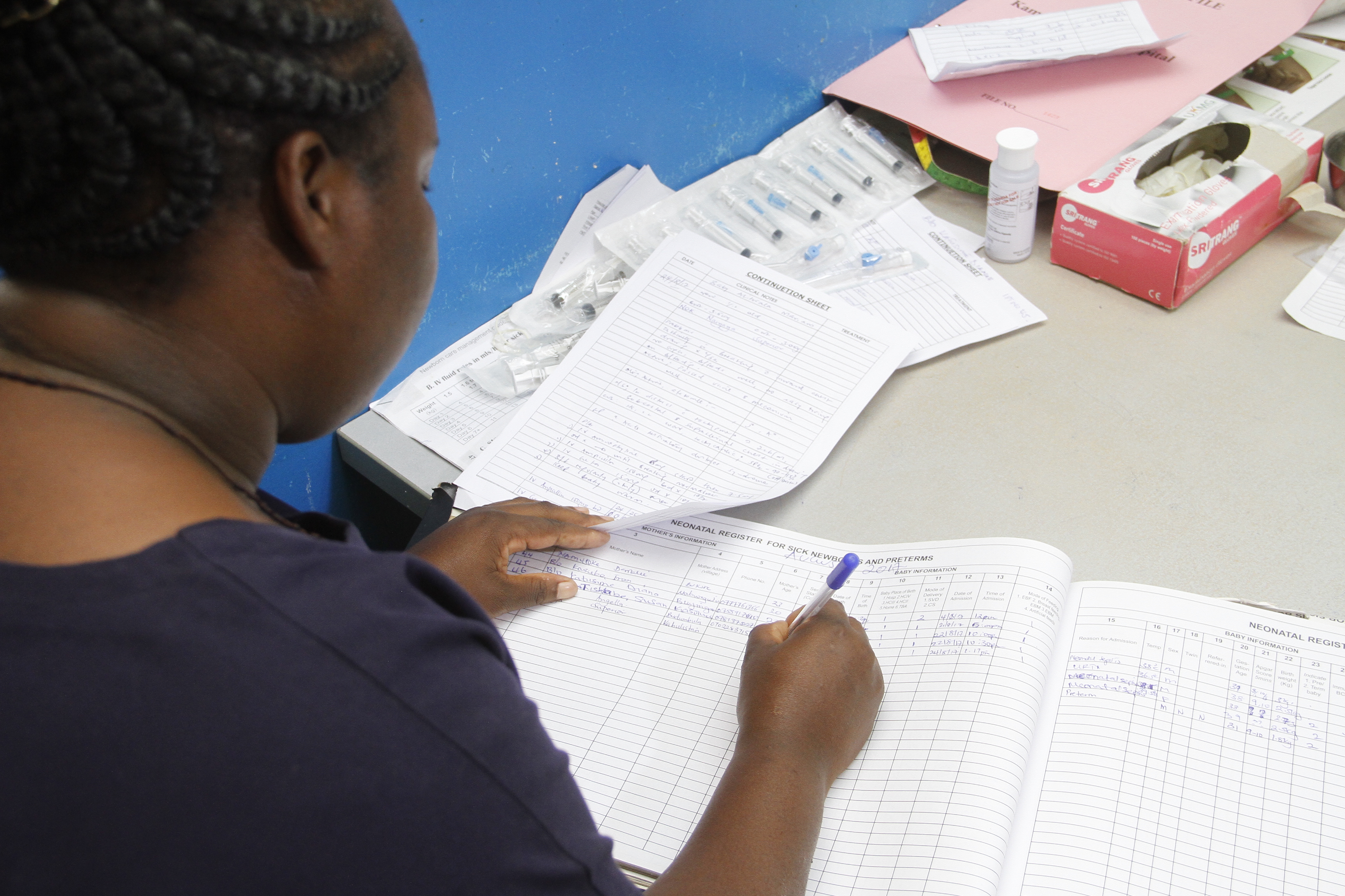 Health worker filling out charts