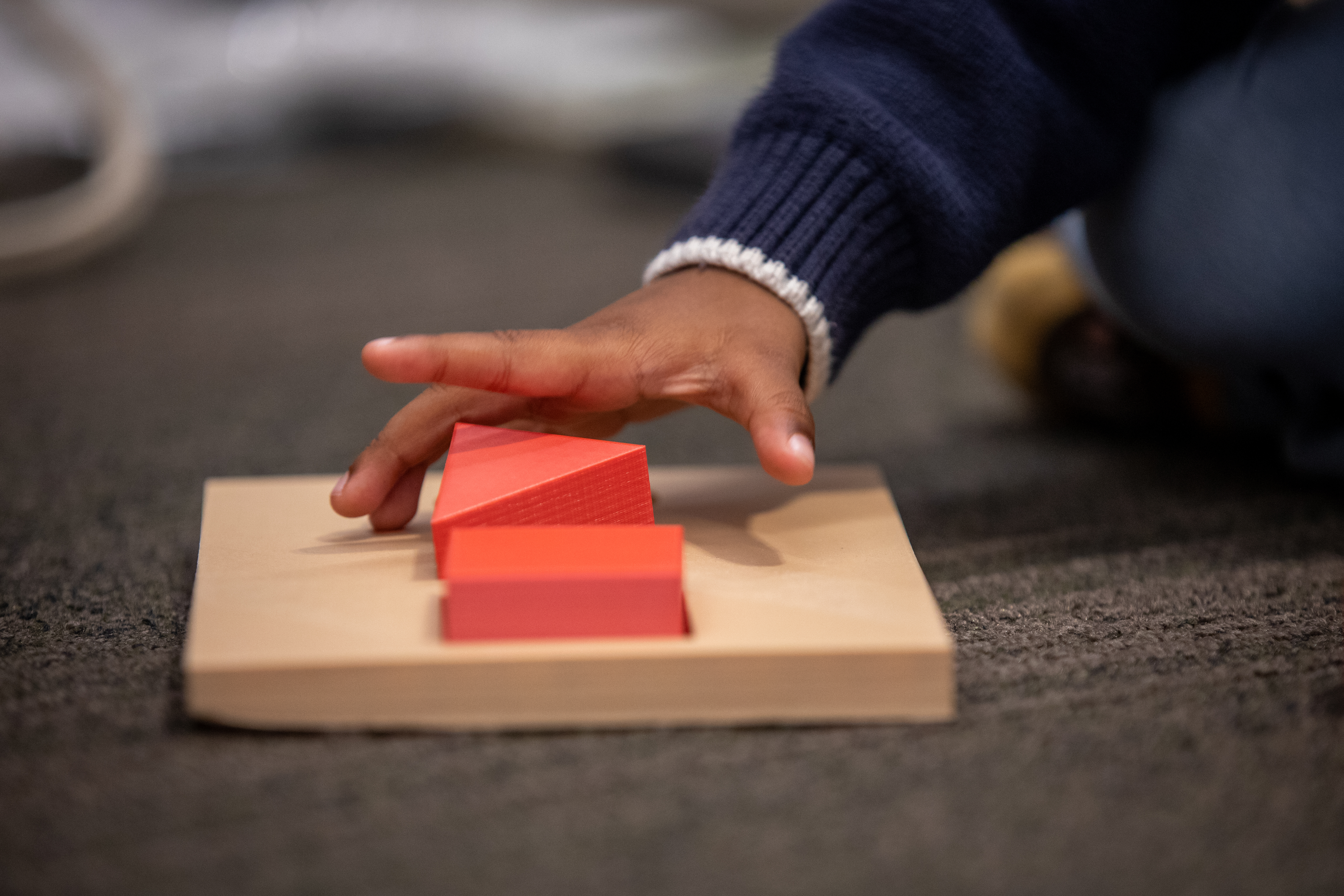 Child's hand playing with a block game