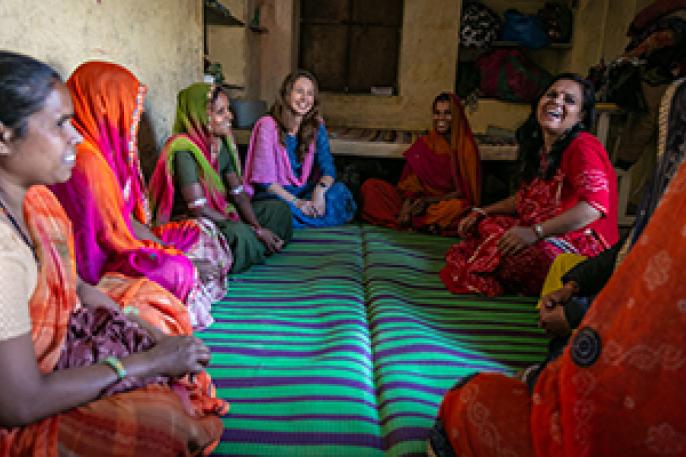 A group of women sit in a circle having a discussion