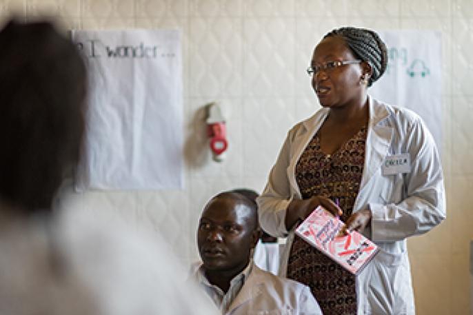 A woman standing up addressing a group