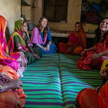 A group of women sit in a circle having a discussion