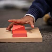 Child's hand playing with a block game